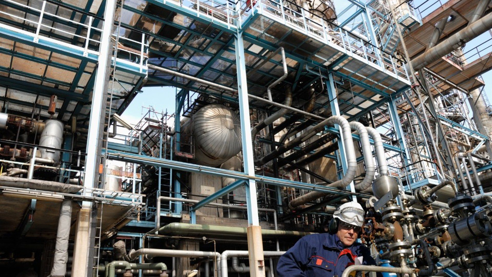 Technician inspecting valves at an industrial plant