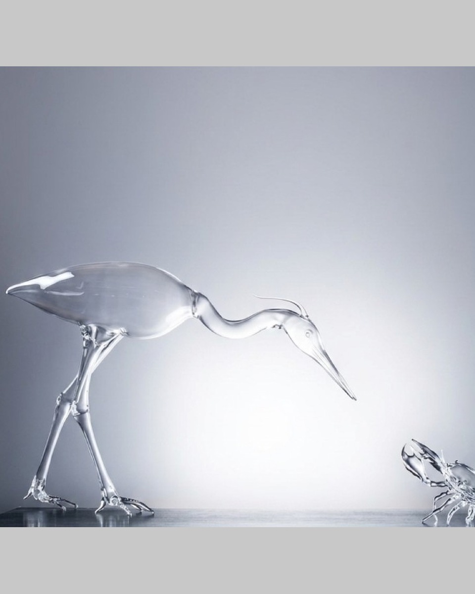 Clear glass heron and crab sculptures