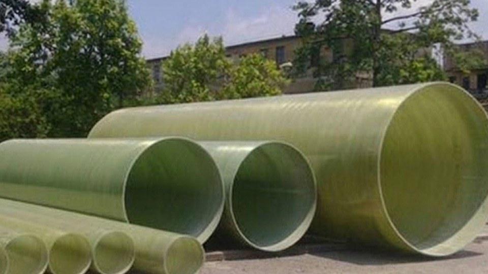 Green GRP pipes at an industrial yard