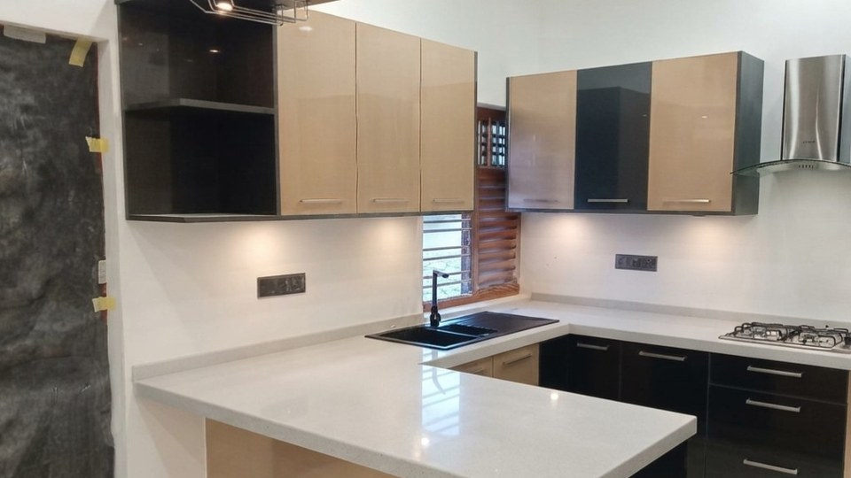 Contemporary kitchen with quartz countertop, dark and beige cabinetry